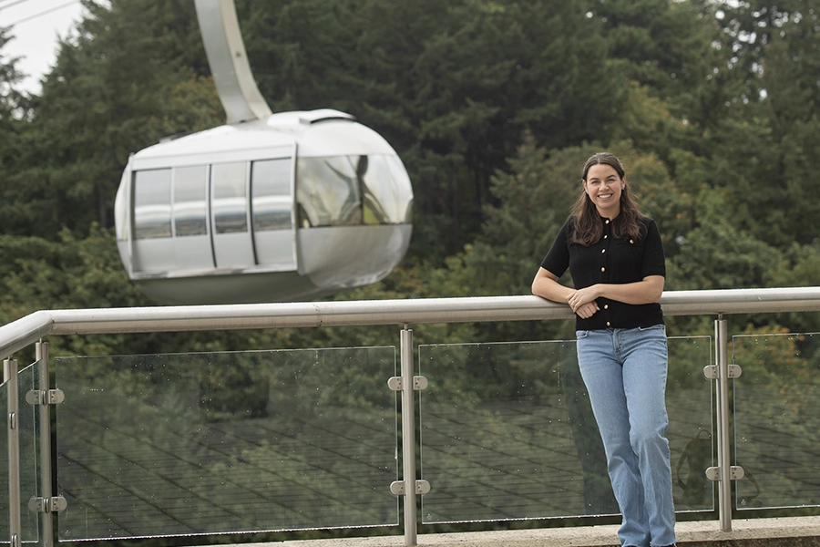 Katie at OHSU standing in front of the aerial tram.