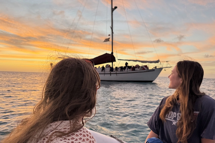 Peyton and a student looking at the boat they stayed on.
