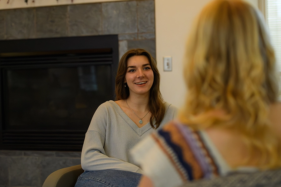 Echo sitting and talking to another student.