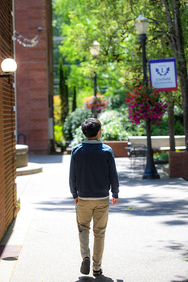 Ernesto walking through campus.