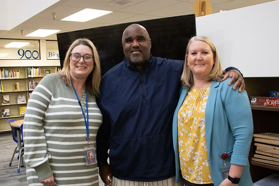 photo of Tramaine along with two other educators.