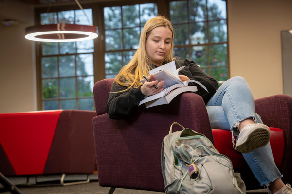 Abby studying in the student lounge of Riley Hall
