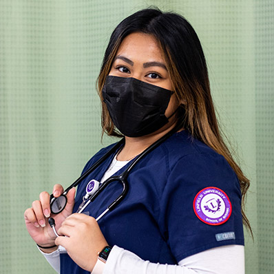 Portrait of Alexie in her nursing scrubs.