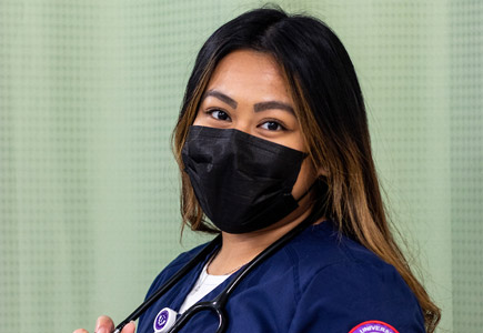 Alexie Joi in her nursing scrubs, face mask and stethoscope around her neck