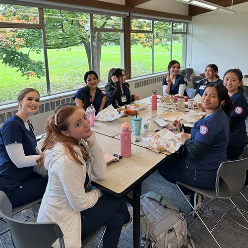 club members painting at a table.