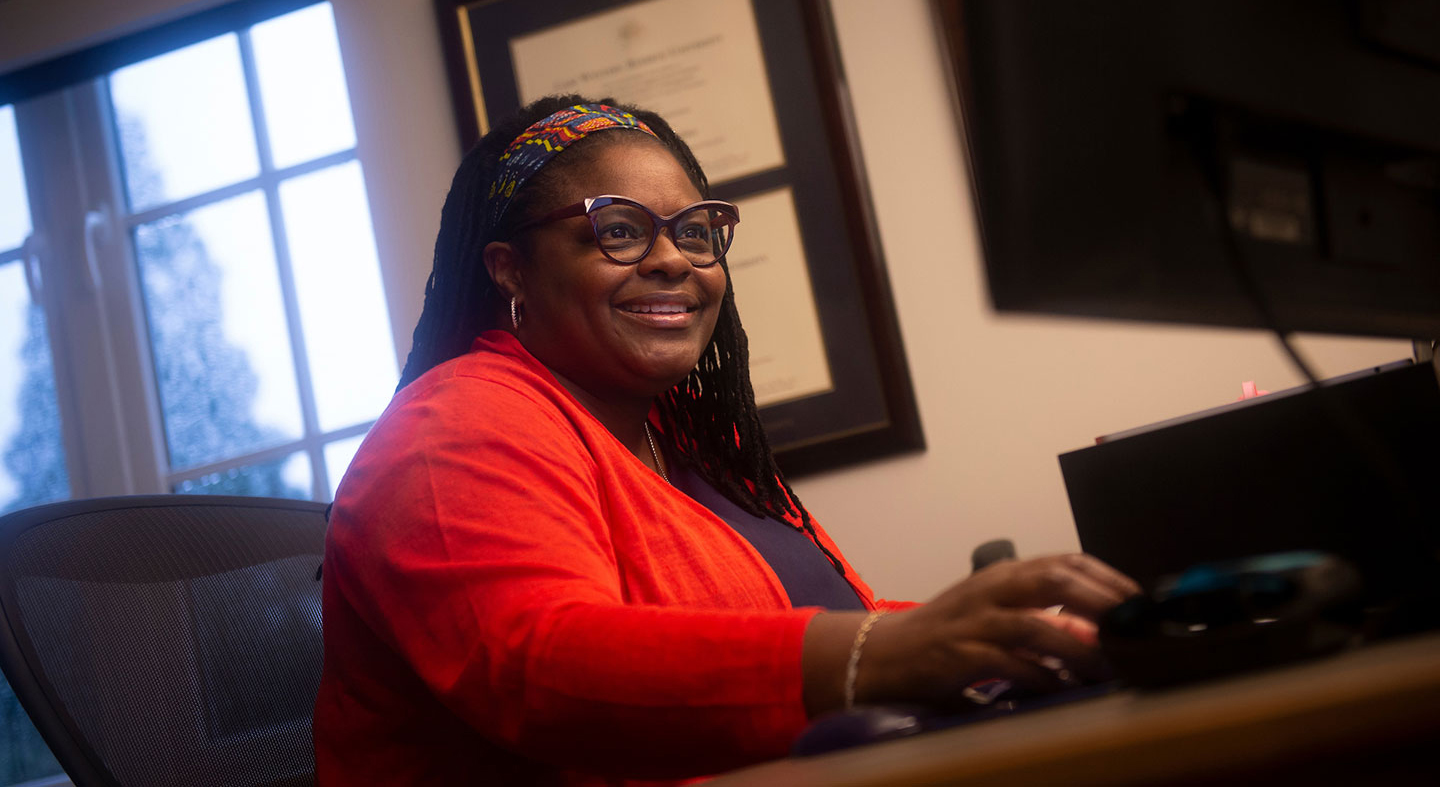 Dean Jennifer Madden working on her computer