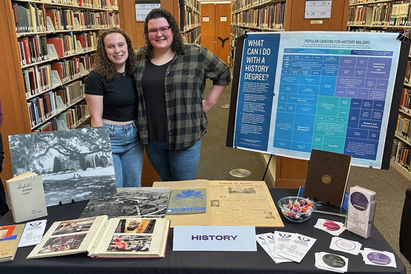 Brooke Brown '23 working in the library with a fellow student.