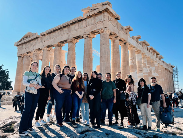Fifteen Linfield students and two professors in front of the Parthenon.