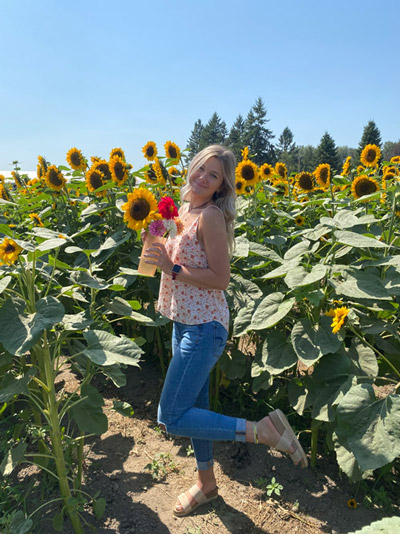 Marissa Dolson in a field of sunflowers.