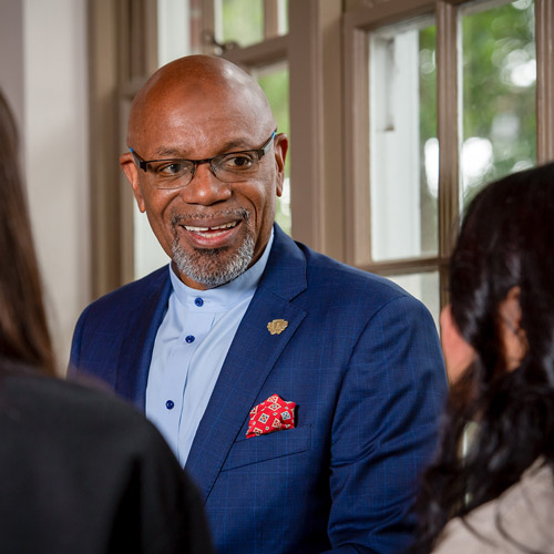 President Davis speaking with two students