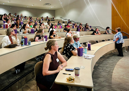 Nursing students in lecture hall during orientation.