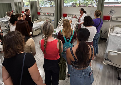 Nursing students watching a demonstration in the Experiential Learning Center.