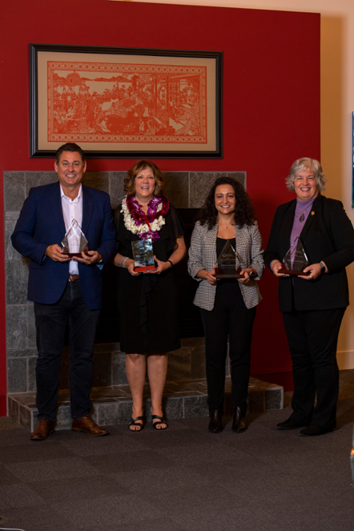 2023 Alumni Award winners stand holding their awards