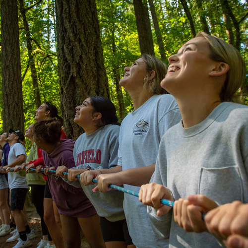 students doing a ropes course activity as part of pre-orientation 2022