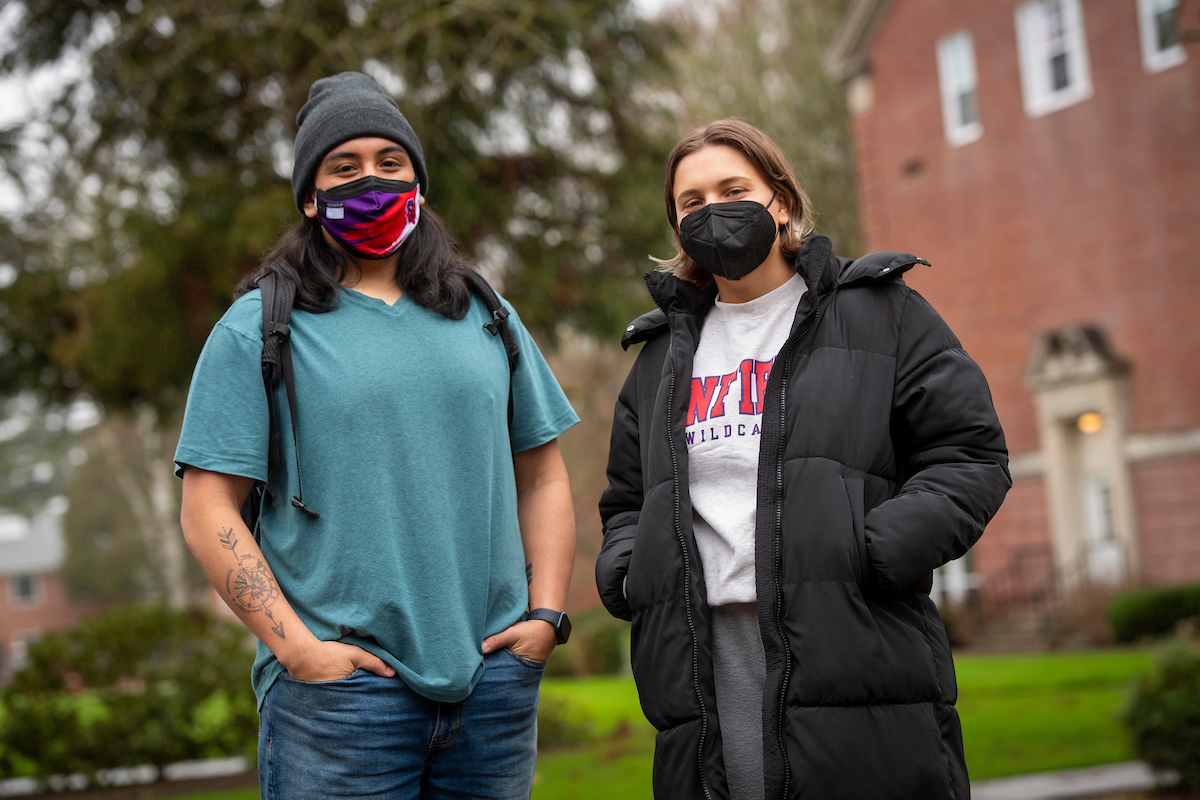 Two students wear KN95 masks outside