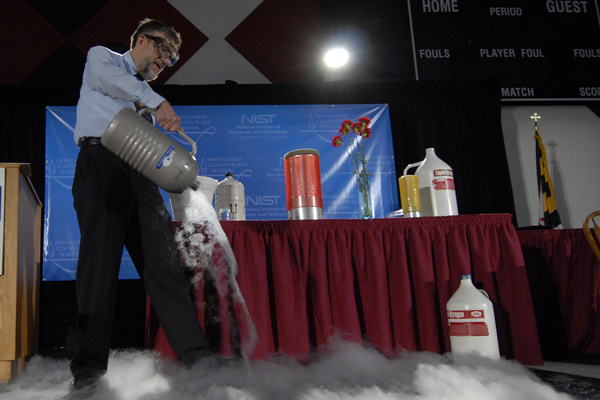 Bill Phillips performing a science experiment on stage.