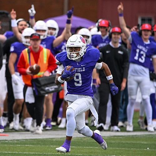 Linfield football player running down the field.