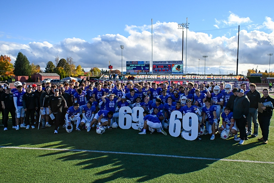 Linfield football team holding the numbers 69 after the Wildcat football win