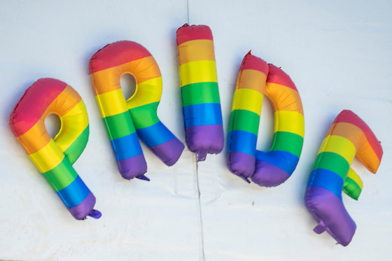 Rainbow balloons spelling out pride