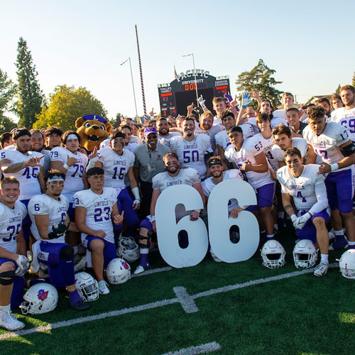 Linfield Wildcats football team holding the numbers 66 after their win on Oct. 15, 2022