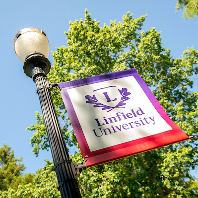 Linfield University banner on a light post.