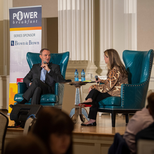 Two guest speakers talking on stage at the Portland Power Breakfast.
