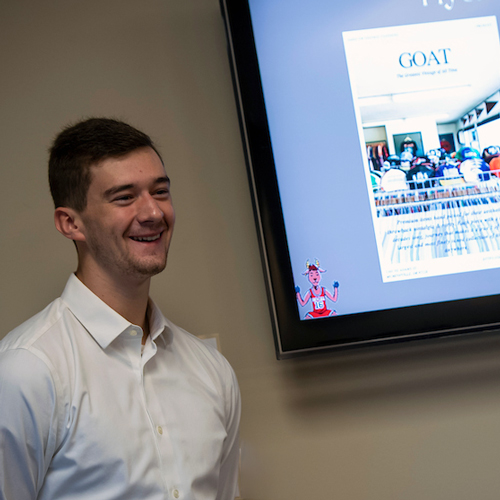 Male student talking during a business presentation.