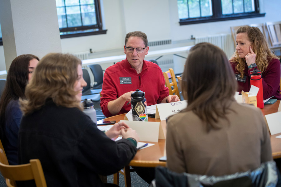 The career development team meeting with four students around a table.