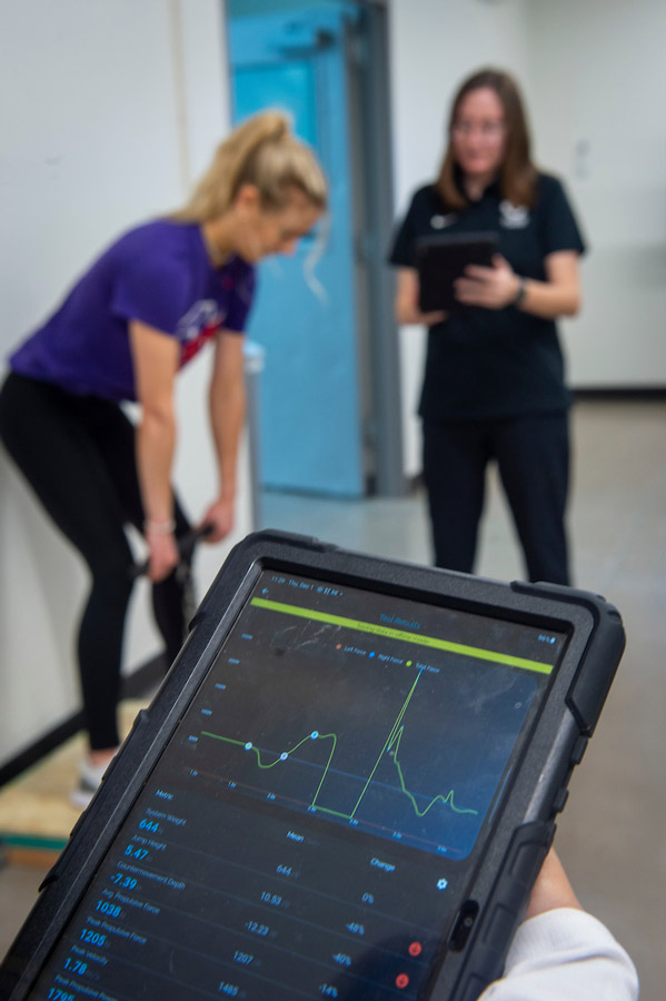 students working with athletes.