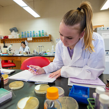 Female student working in a new science lab.