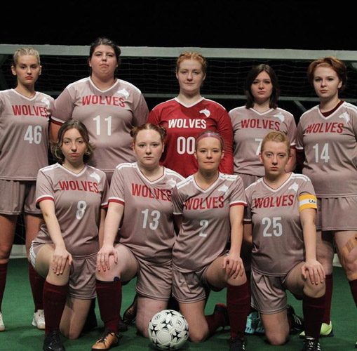 Nine members of the soccer team from The Wolves.