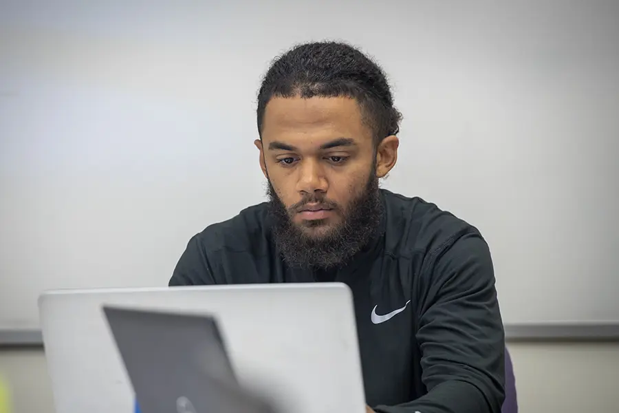 student studying on a laptop.