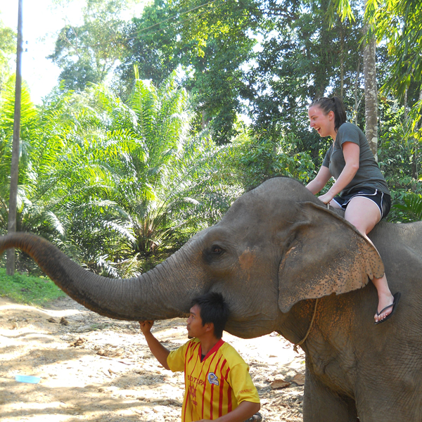 student riding an elephant