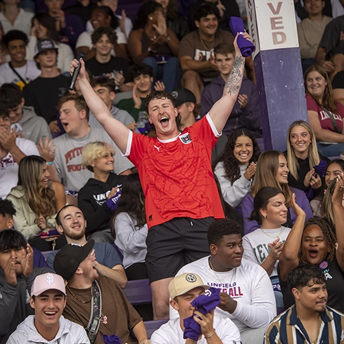 student cheering in the stands at Cat Camp.