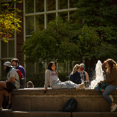 students visiting between classes at the fountain outside Walker Hall