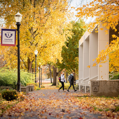 two students walking into Linfield Nicholson Library in the fall
