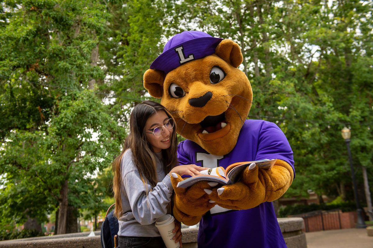 Mack with student and a book