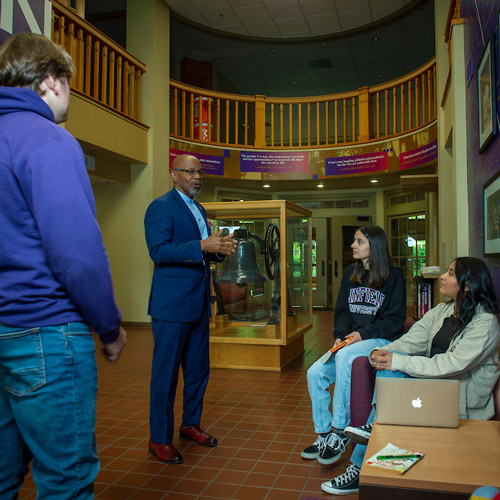 President Davis talking with four students in Riley Hall