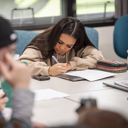 student studying at a table.