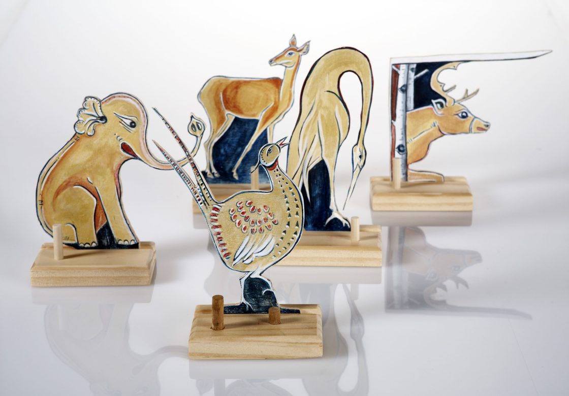 Woodwork from artist Belle Bezdicek of animal figurines painted in a folkloric style.