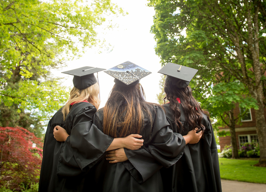 three students posing in regalia.