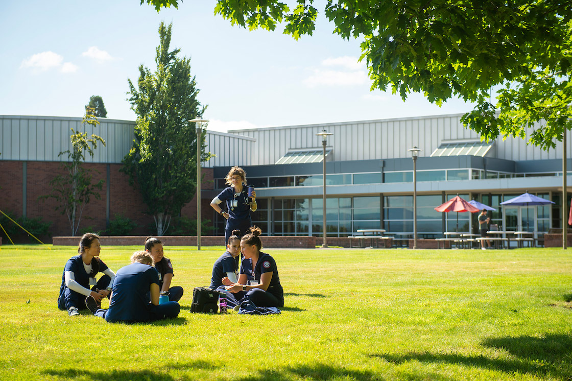 Students sit outside at Portland campus
