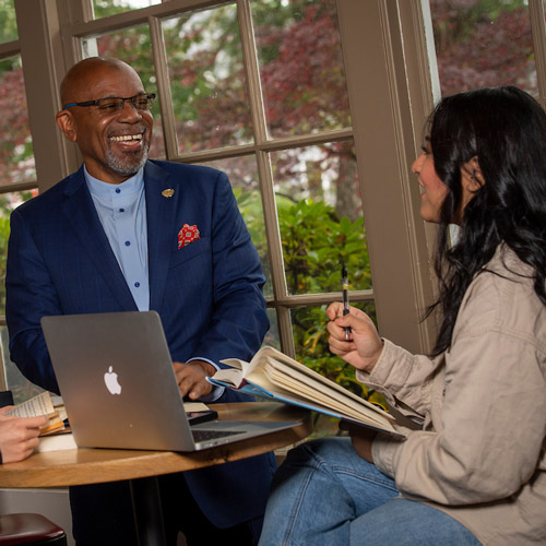President Davis laughing with students in Starbucks.