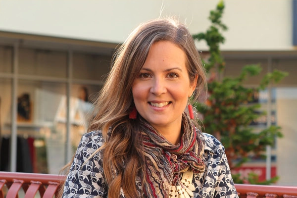 A female professional sitting on a bench outside