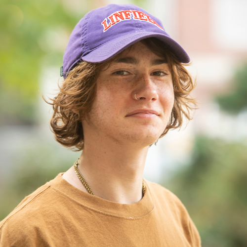 Portrait of a smiling student wearing a Linfield hat.