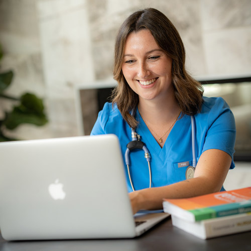 Nursing student studying on her laptop