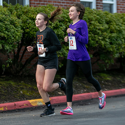 photo of two students running.