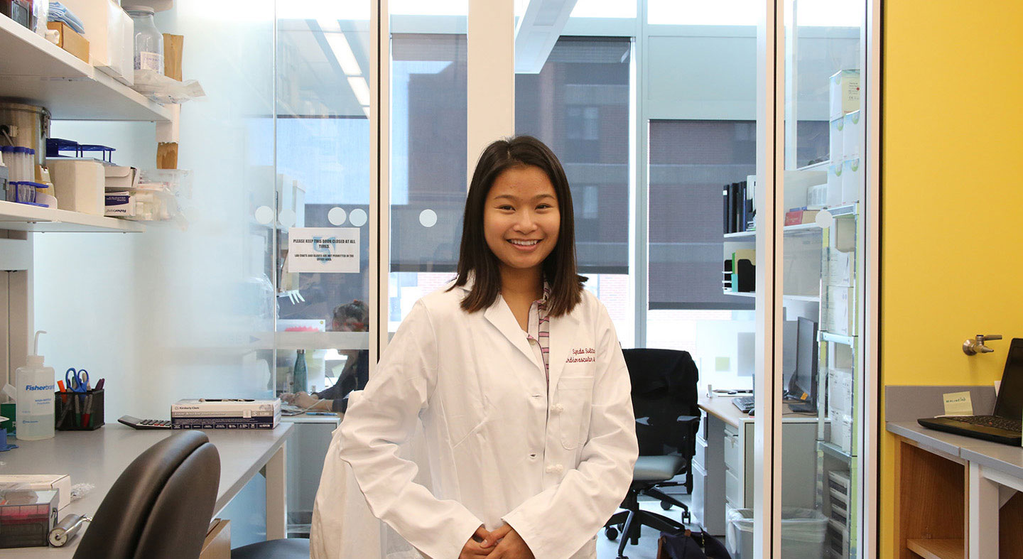 student working in a hospital setting conducting research