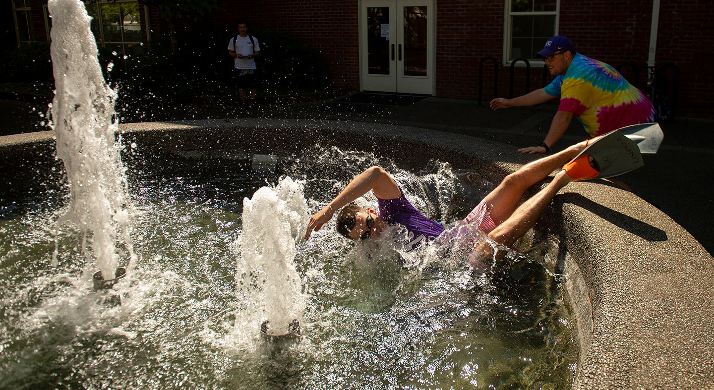 student swim in the fountain