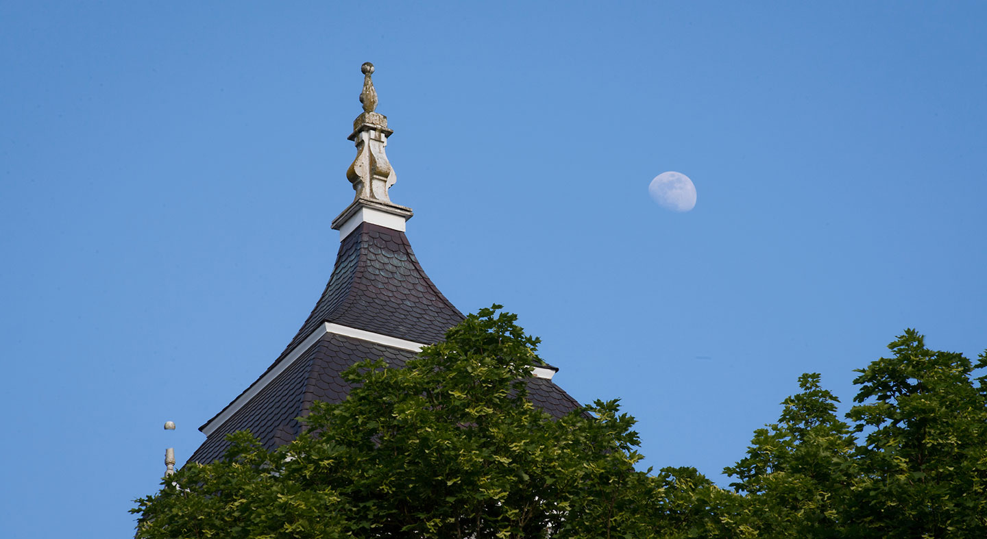 The top of Pioneer Hall and the moon